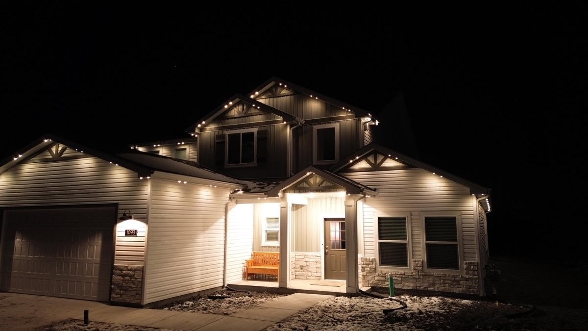 Permanent LED mood lighting creating a warm glow on a modern farmhouse in the Salt Lake Valley