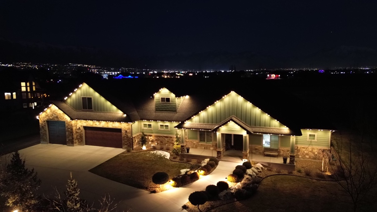 Salt Lake City luxury home with TruLight 48-volt permanent lighting illuminating the roofline at night