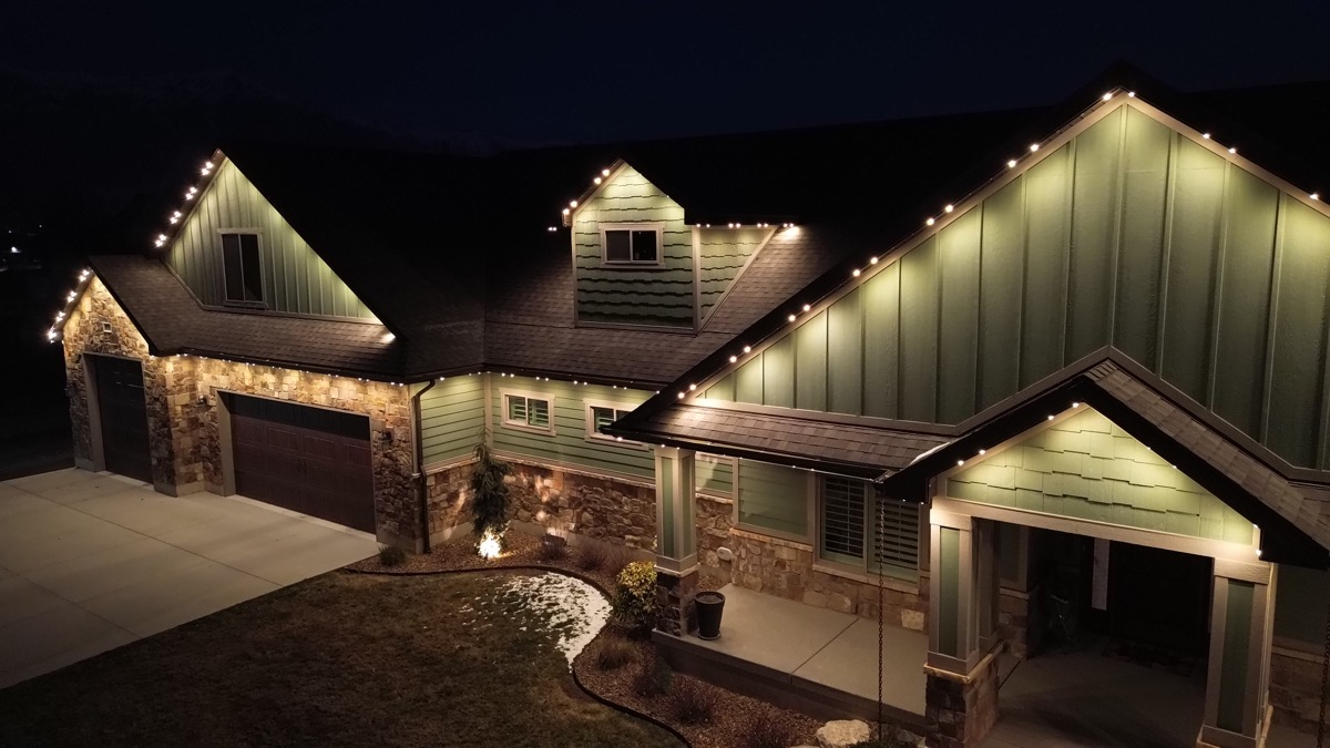 Aerial view of permanent LED lighting installation on a Salt Lake City home with composition shingle roof