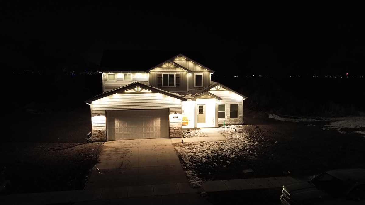 Smart permanent lighting with automated zones on a Salt Lake City home at night